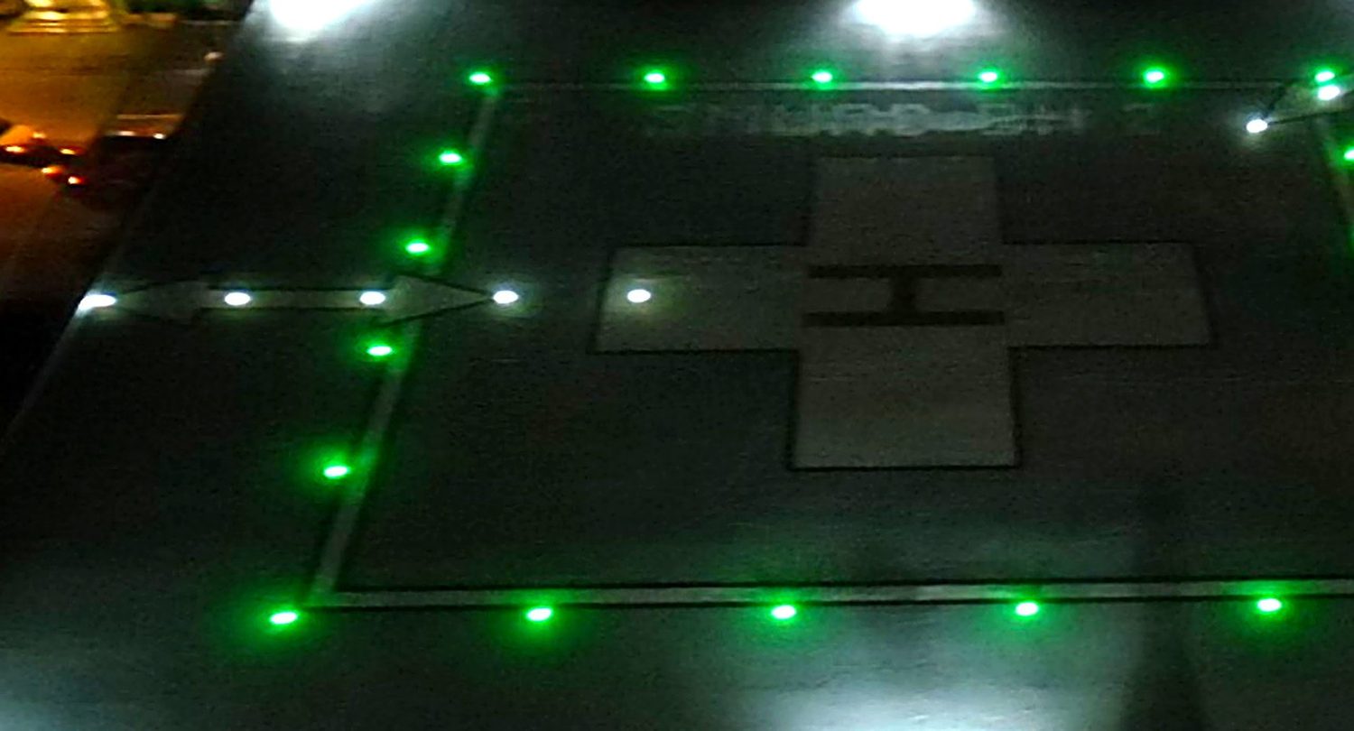 Lit rooftop helipad at night