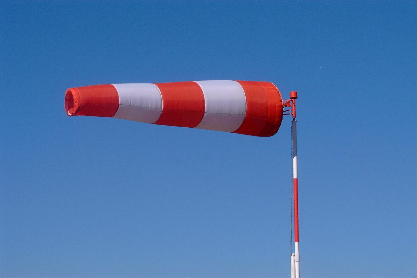 Onshore windsock against blue sky